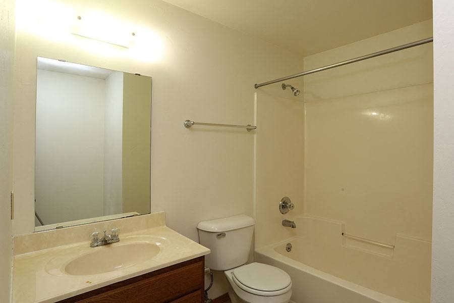 A bathroom with a toilet, sink, and bathtub.