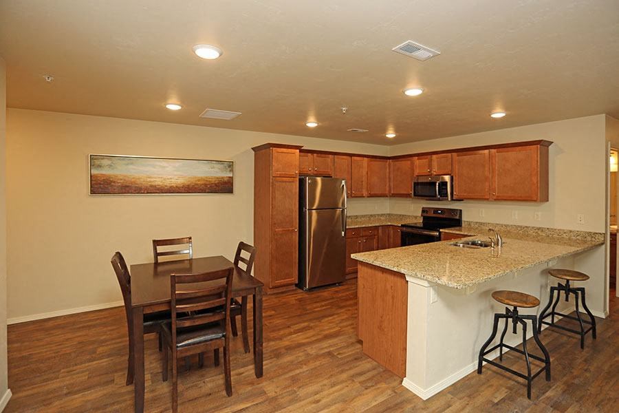 a kitchen with a bar and a dining table