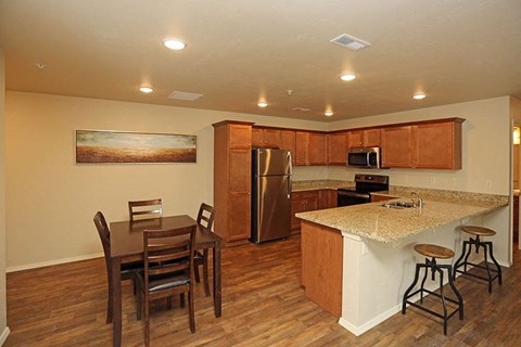 a kitchen with a bar and a dining table