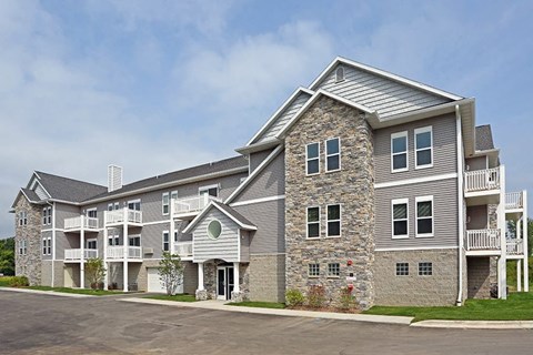 a large apartment building with a parking lot