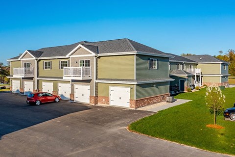 a house with a red car parked in front of it
