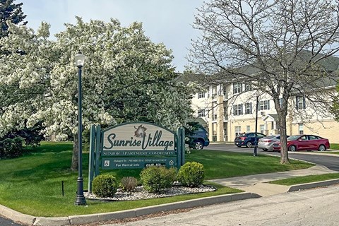 Sunrise Village sign in front of a building.