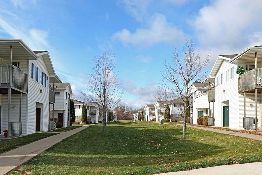 a row of houses on the side of a lawn