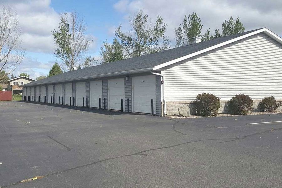 a white building with a row of garage doors