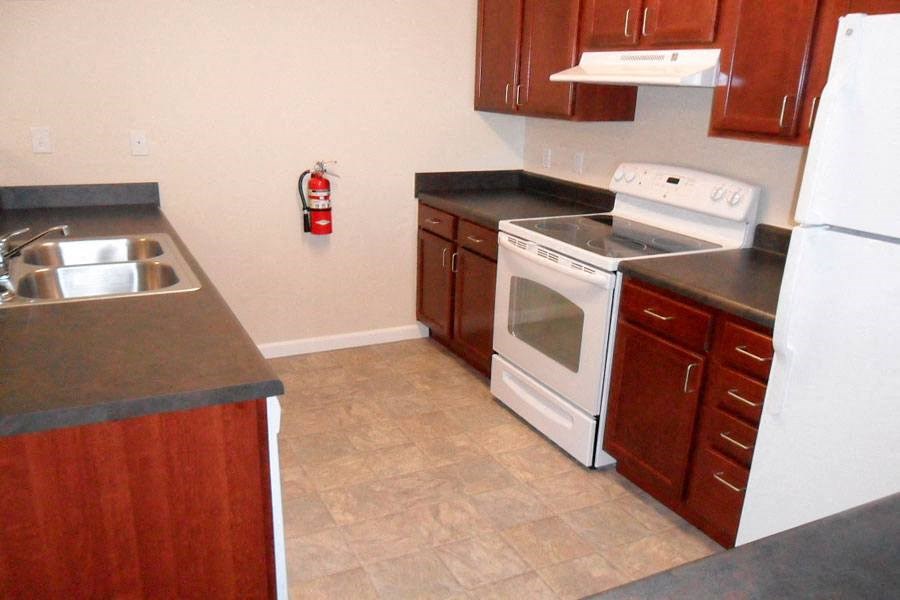 a kitchen with a stove refrigerator and a sink