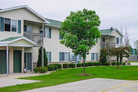 a white house with a tree in front of it