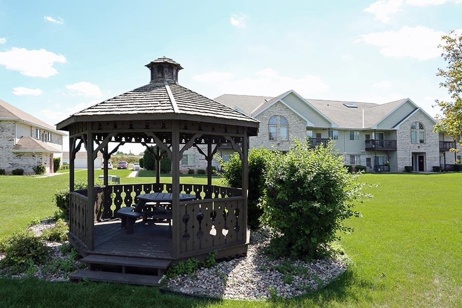 a gazebo in the yard of a house