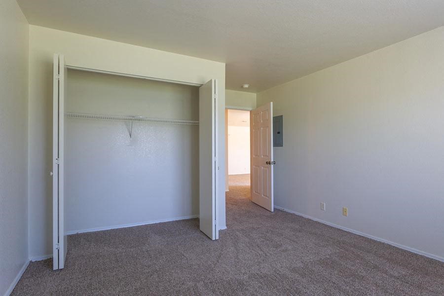 an empty room with a closet and a door