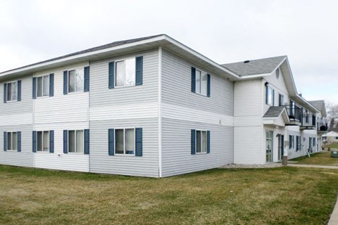 a white house with a lawn in front of it