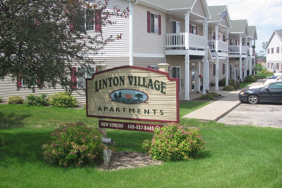 a sign for the union village apartments in front of a house