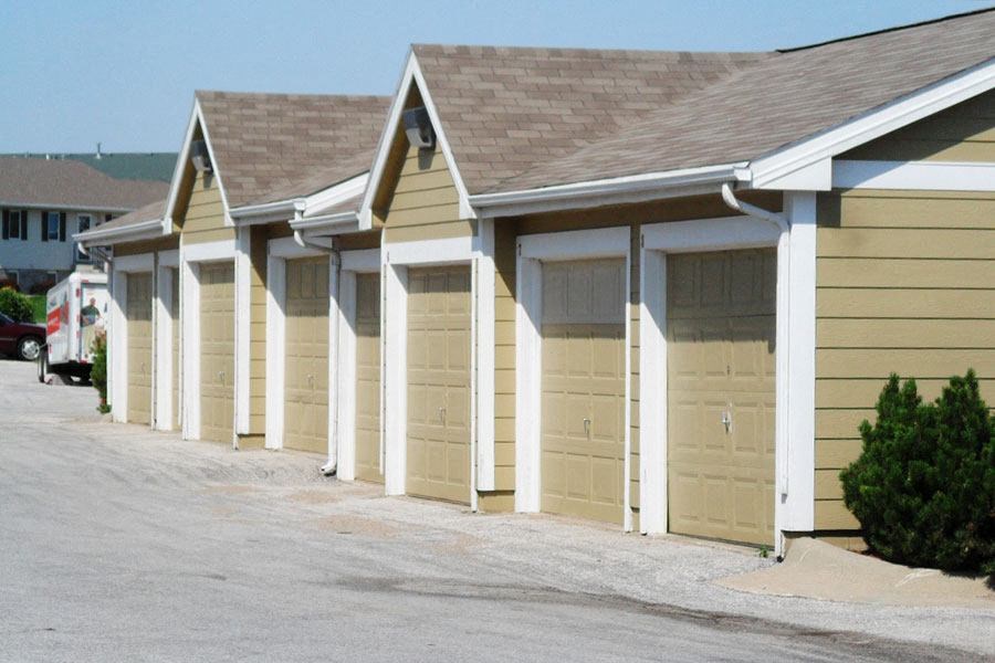a row of garage doors on a parking lot