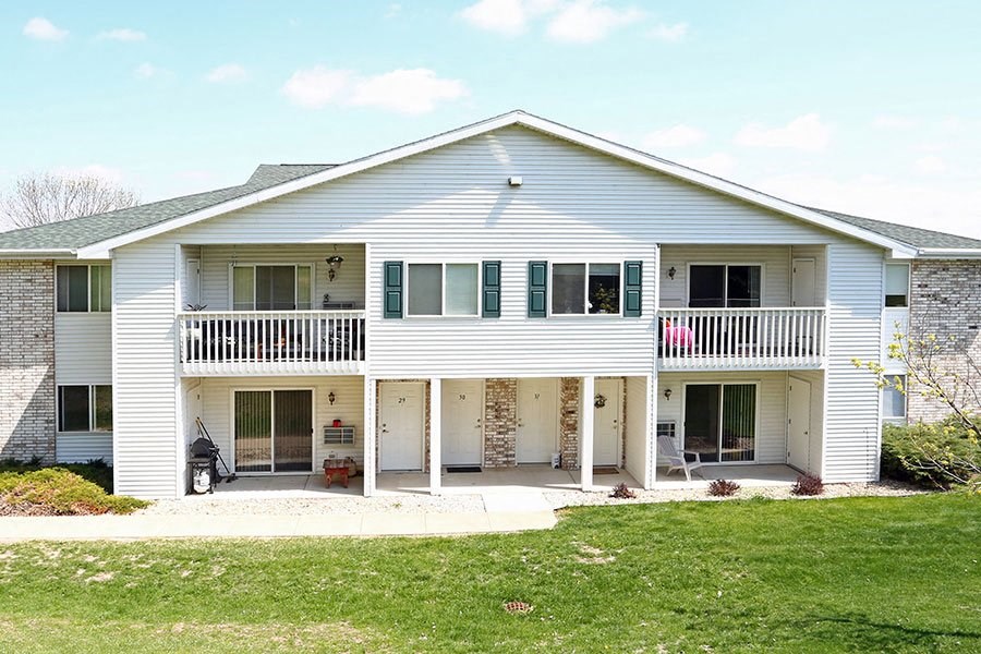 a white house with a porch and a lawn