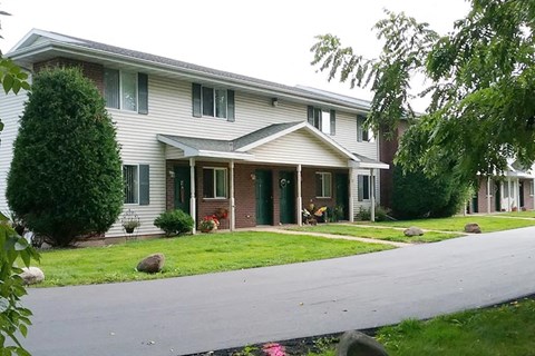 a white house with a yard and a street