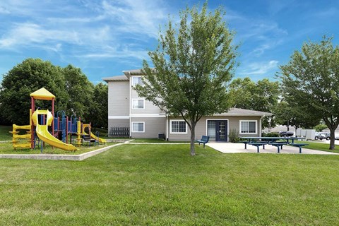 a yard with a playground and a house