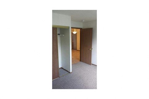 a hallway with a mirror and a closet
