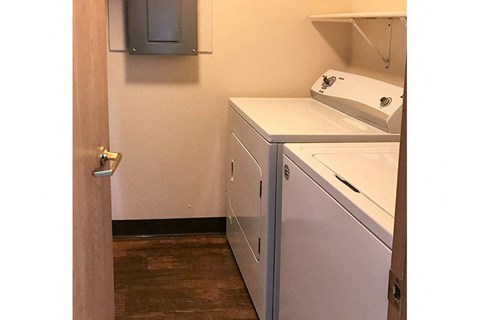 a white washer and dryer in a room with a door