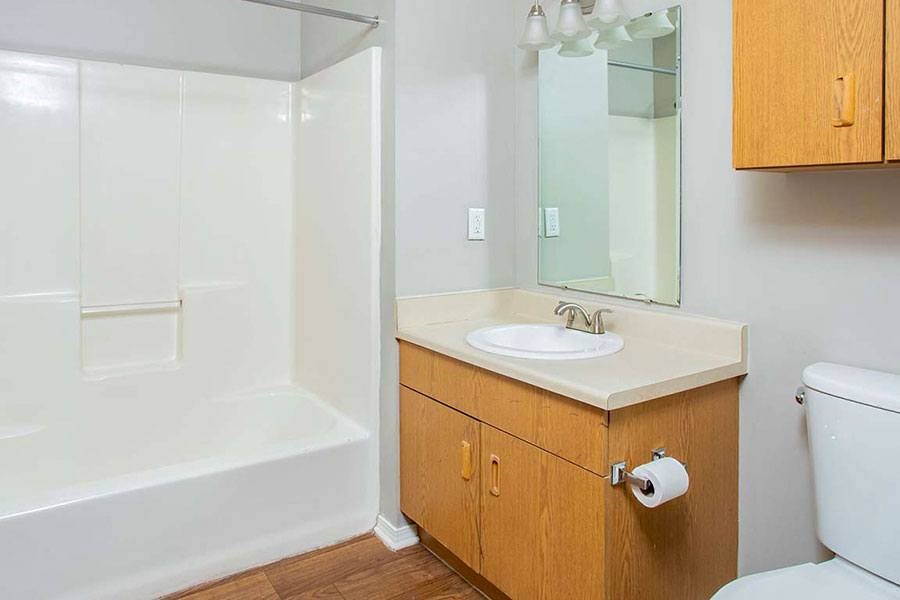 A bathroom with a sink, toilet, and bathtub.