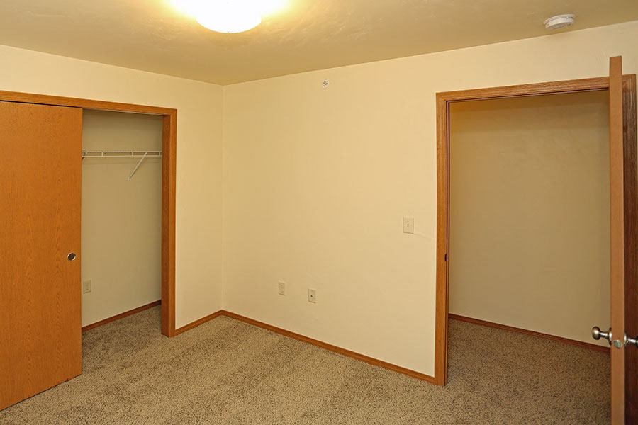 an empty room with a closet and a door