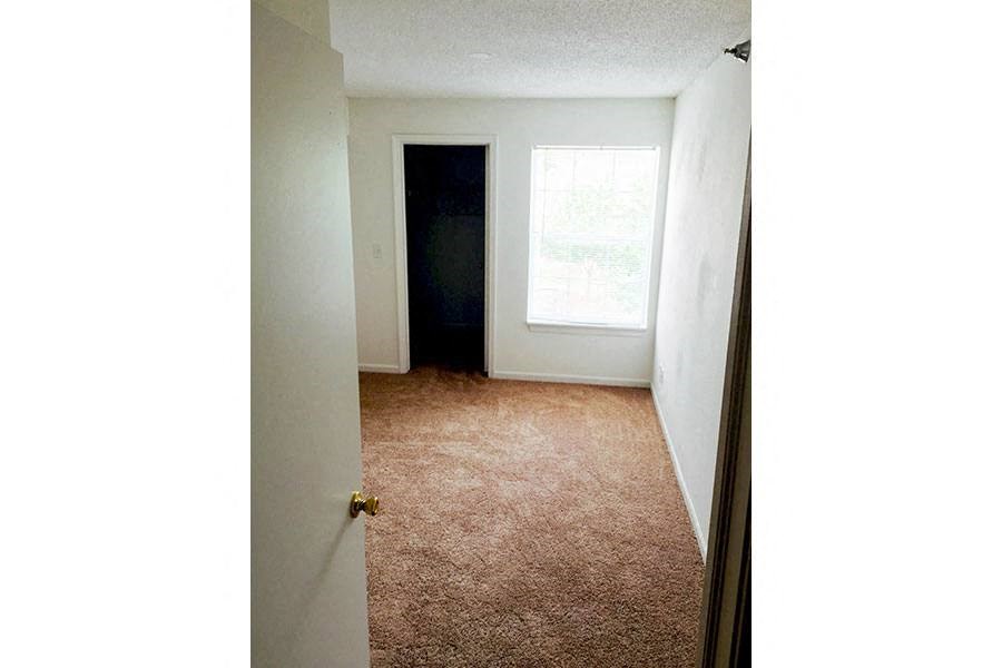 an empty room with a door and a window