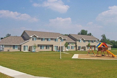 a playground in front of a group of houses