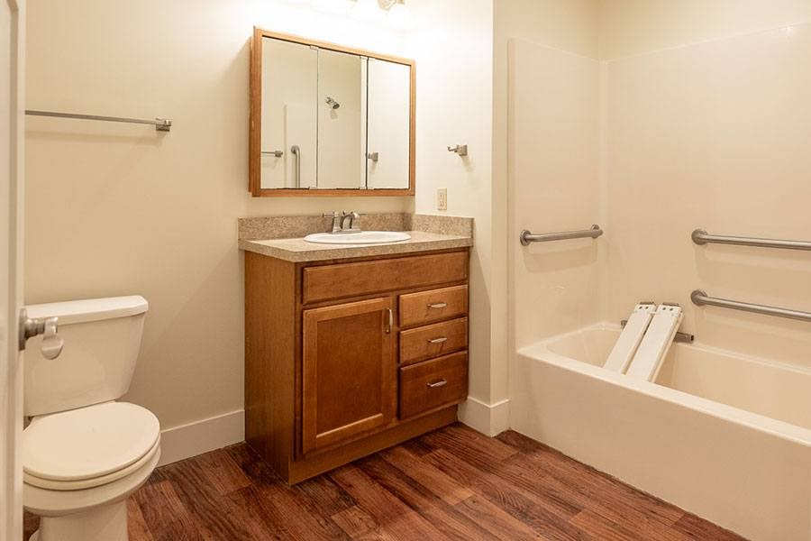A bathroom with a toilet, sink, and bathtub.