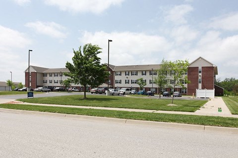 A large building with a parking lot in front.