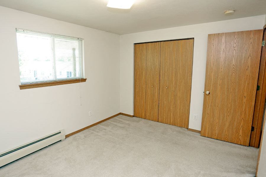 an empty room with a door and a window