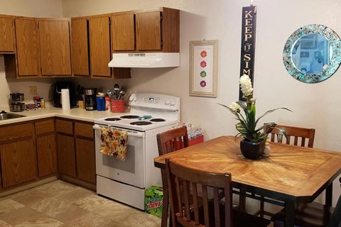 a kitchen with a wooden table and a stove