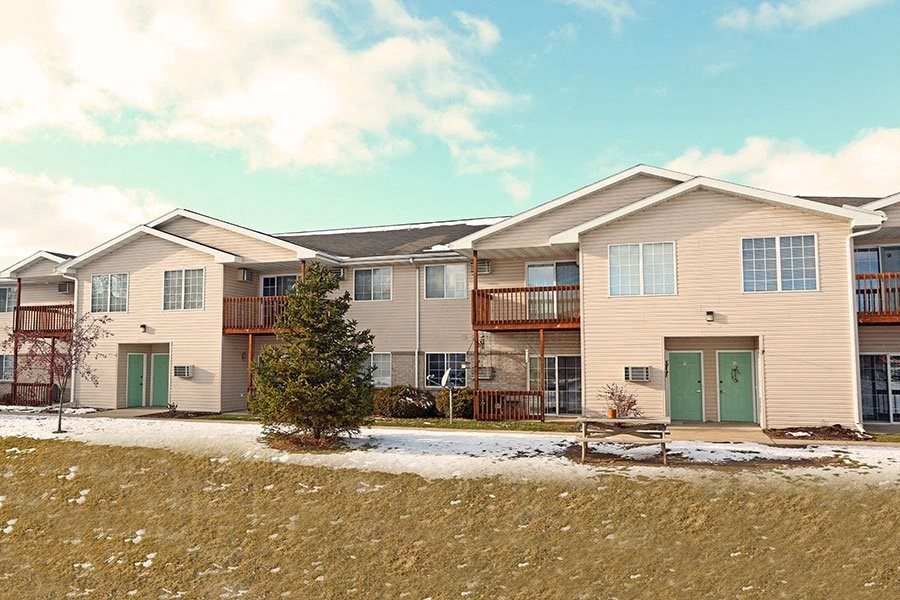 a row of town houses with green doors