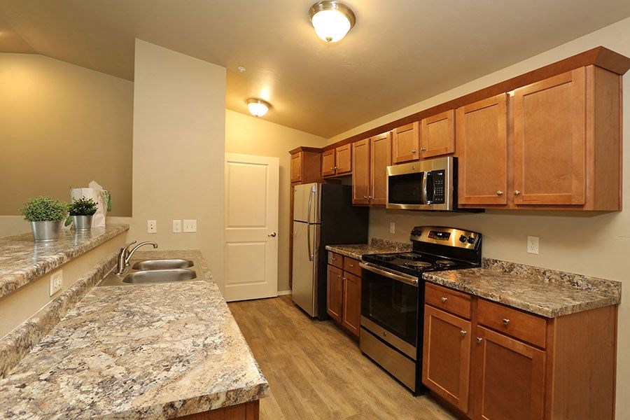 a kitchen with granite counter tops and stainless steel appliances