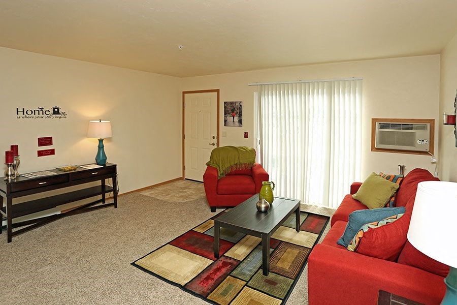 a living room with red furniture and a table