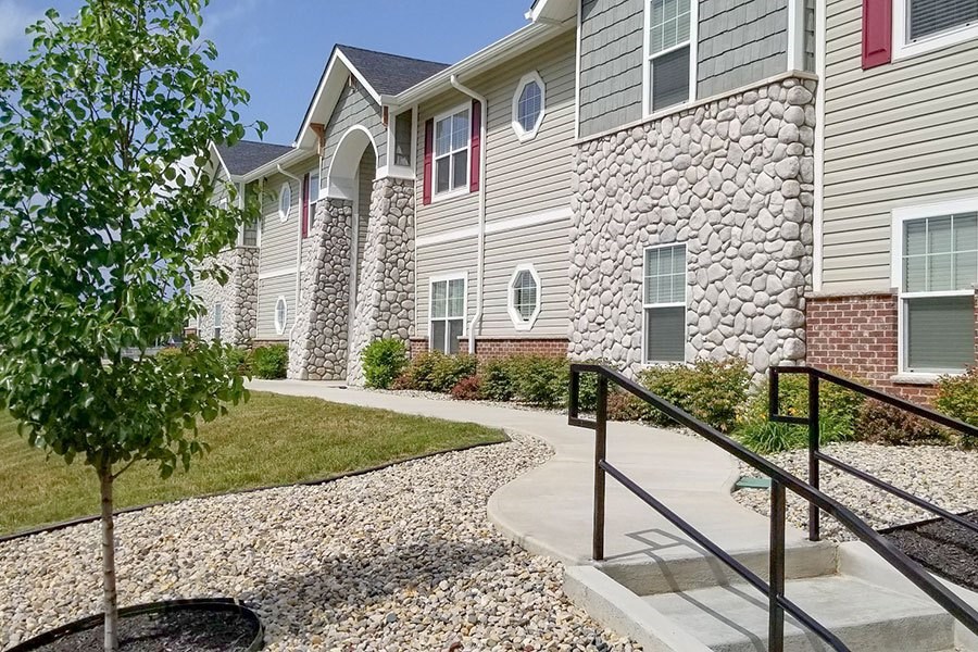 A stone wall is on the side of a building.
