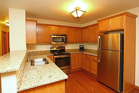 a kitchen with stainless steel appliances and granite counter tops