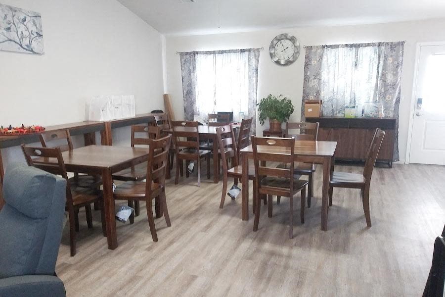 a large dining room with wooden tables and chairs