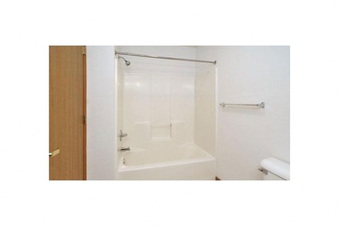 a white bathroom with a shower and a toilet