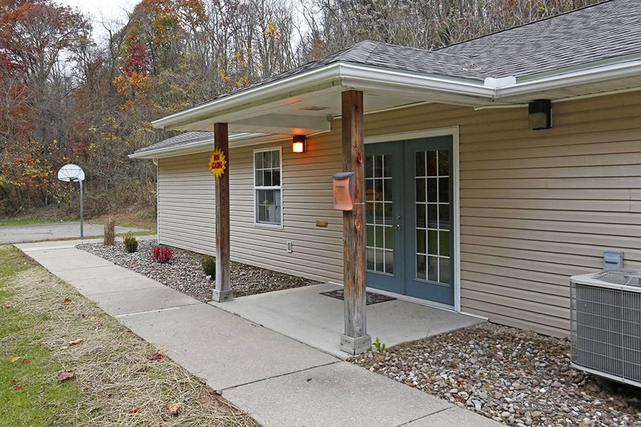 a front porch of a home with a walkway and a blue door