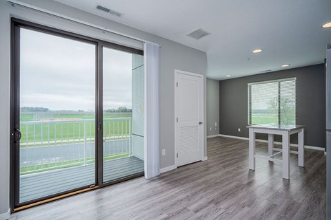 A room with a sliding glass door and a white door.