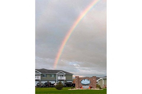 a rainbow in the sky over a house