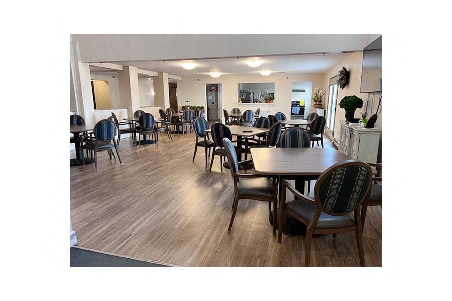 a large dining room with tables and chairs