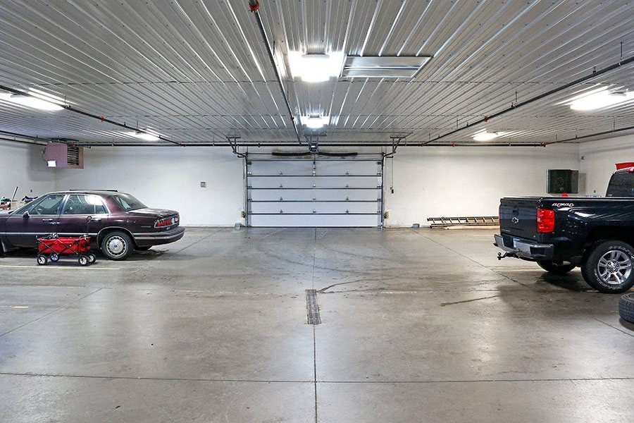 a parking garage with two cars parked in it