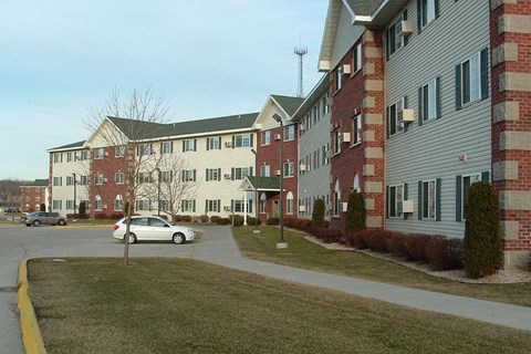 a white car parked in front of an apartment building