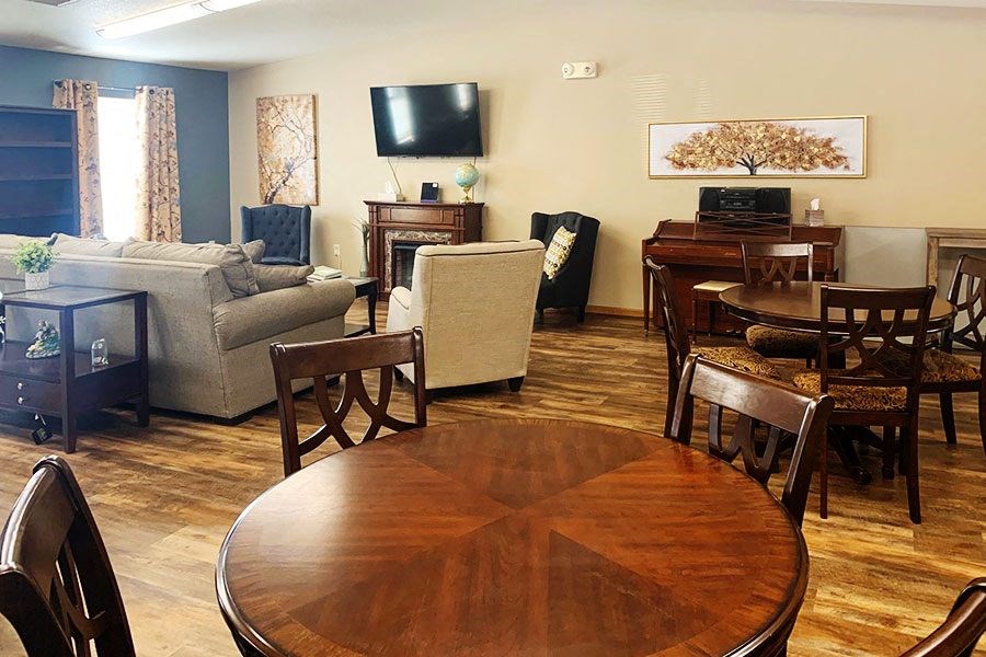 a living room and dining room with a table and chairs