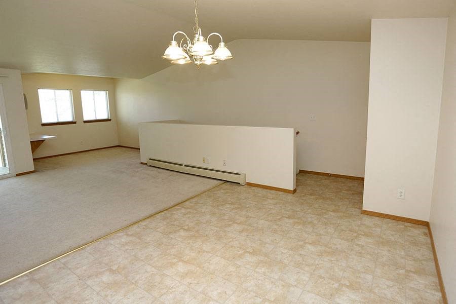 an empty living room with a couch in it