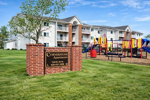A sign for Cornerstone Apartments is in front of apartment buildings.