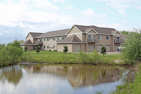 a large house sitting next to a body of water