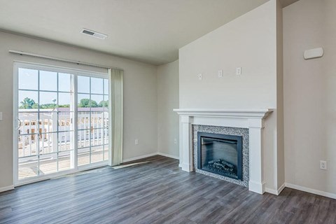 A living room with a fireplace and sliding glass doors.