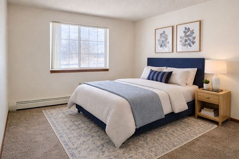 A bedroom with a large bed and a window.
