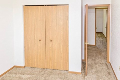 an empty room with a closet and a door