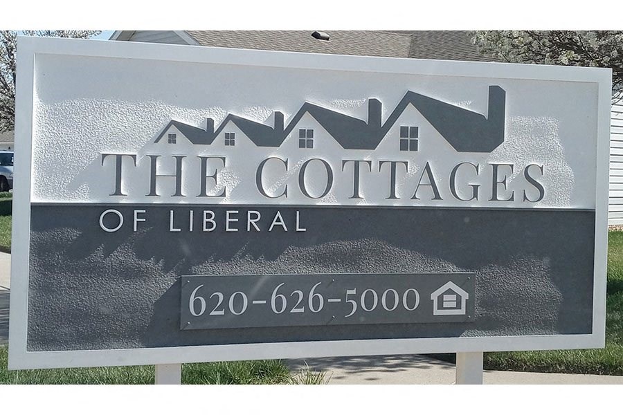 the cottages of liberal sign in front of a house