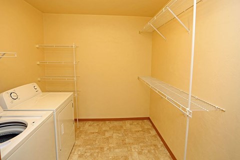 a laundry room with a washing machine and a closet